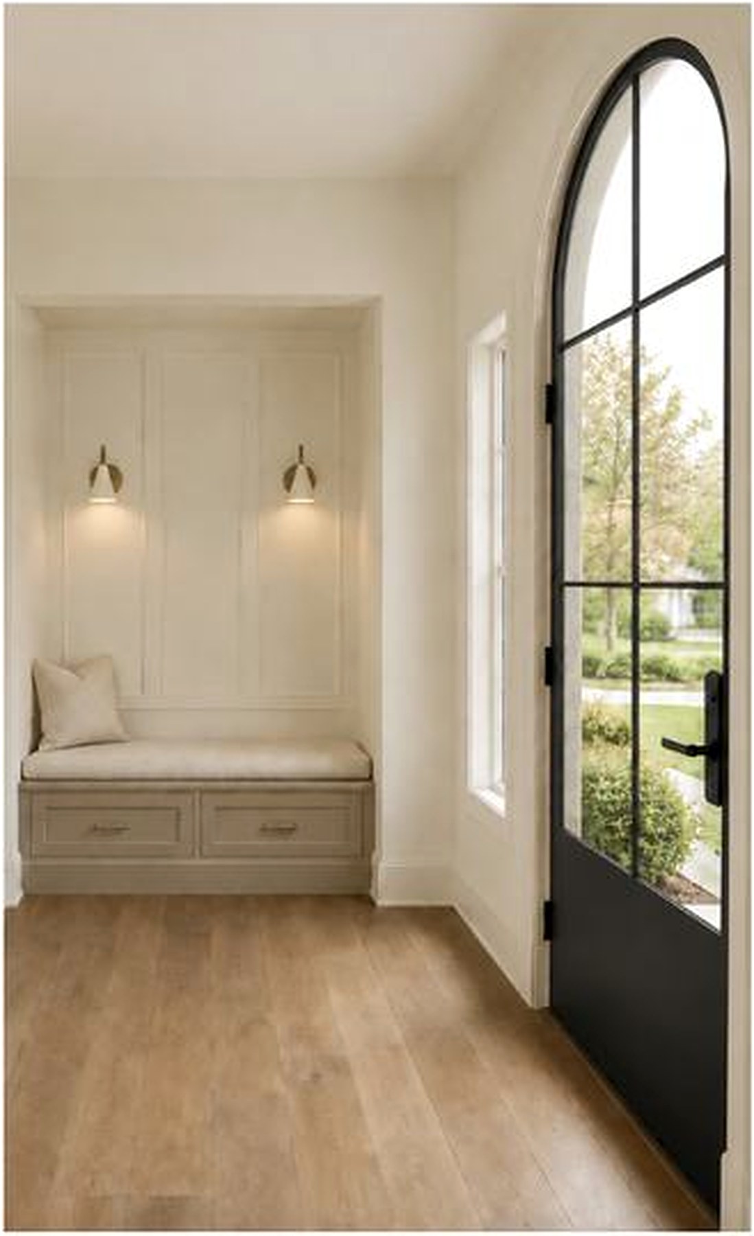 Foyer design visualization with arched black entry door and built-in bench